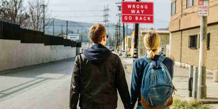 Couple and Wrong Way sign
