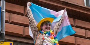 Woman waving trans flag